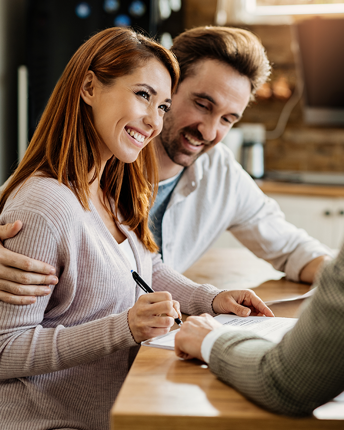 young-happy-woman-her-husband-signing-agreement-with-insurance-agent-meeting